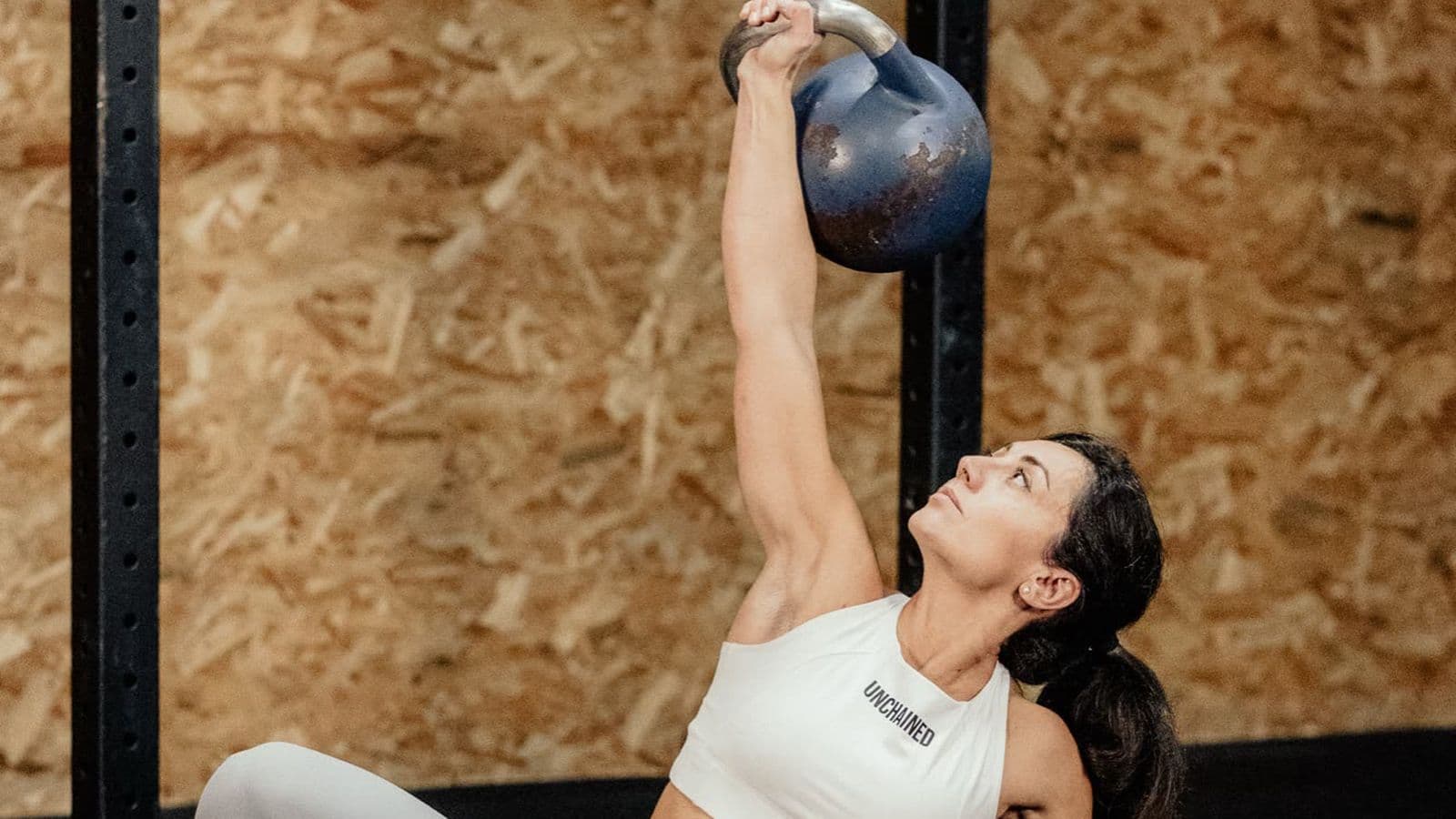 Athlete performing a Turkish get-up, arm locked out overhead with a kettlebell